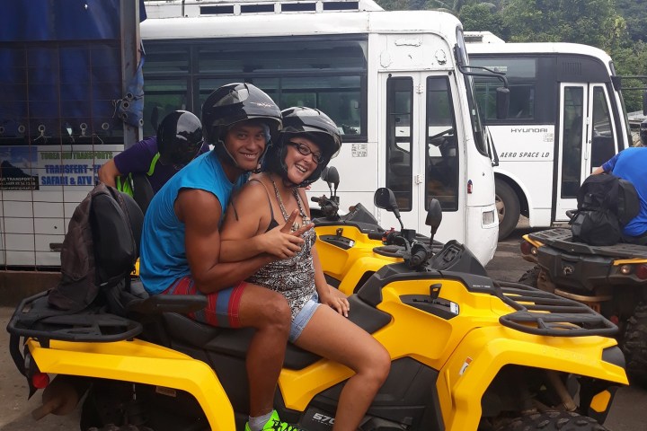 a yellow and black truck sitting on top of a car
