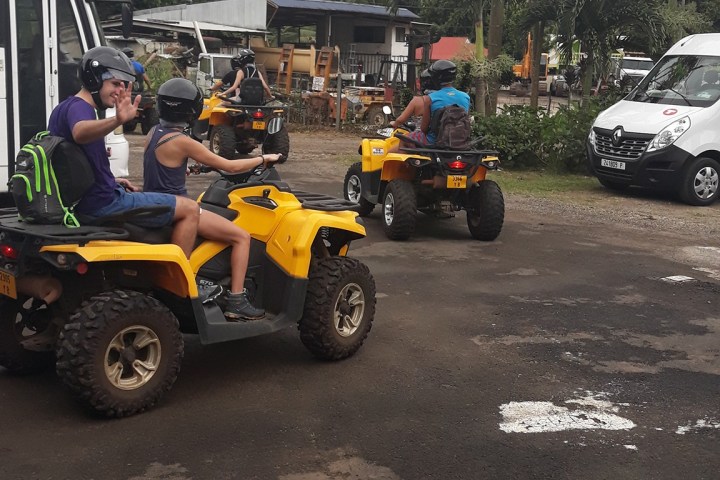 a group of people riding on the back of a truck
