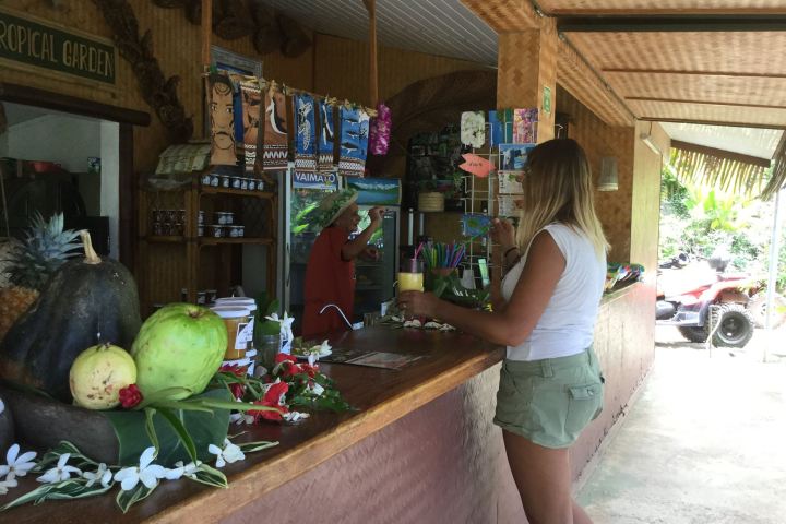 a woman standing in front of a fruit stand