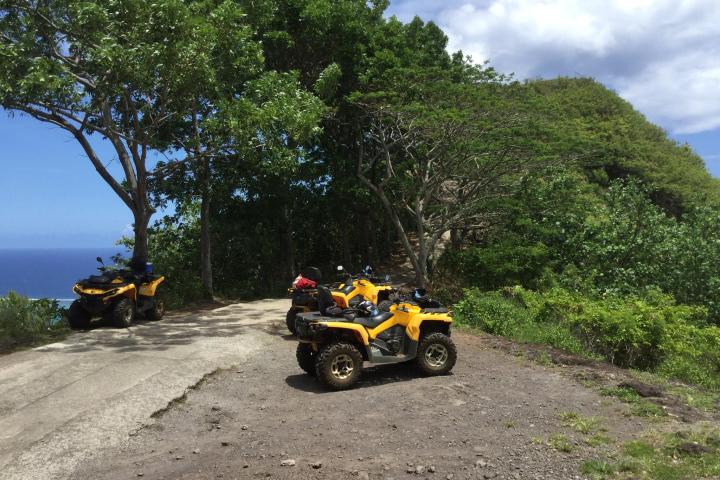 a motorcycle is parked on the side of a dirt road
