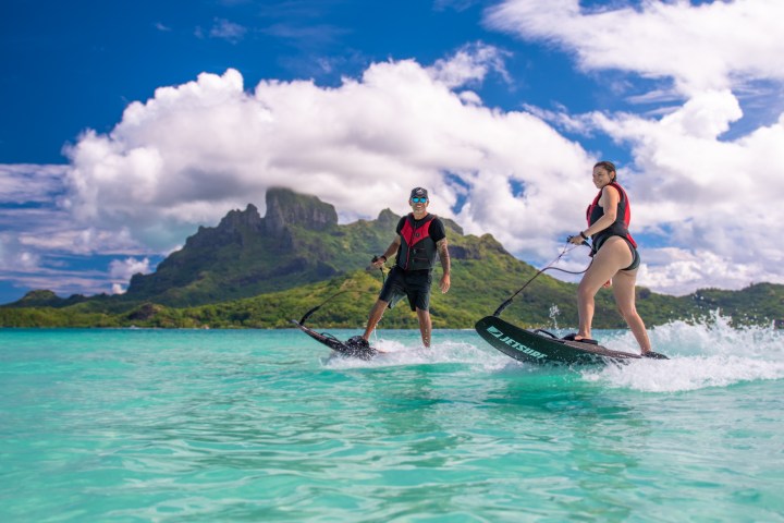 a man riding a wave on a surfboard in the water