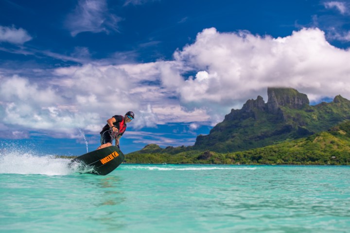 a body of water with a mountain in the background